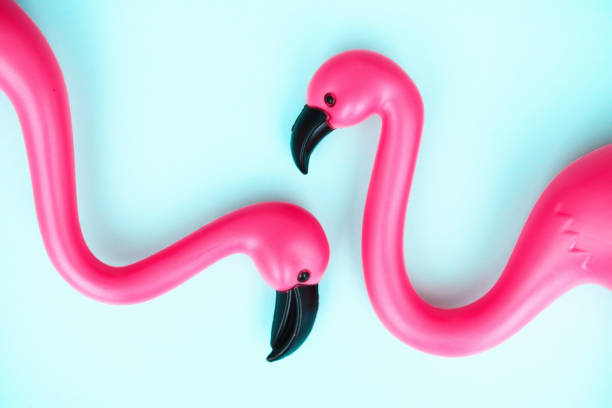 istock Summer background with a flamingo couple on a bright blue background 1386790570