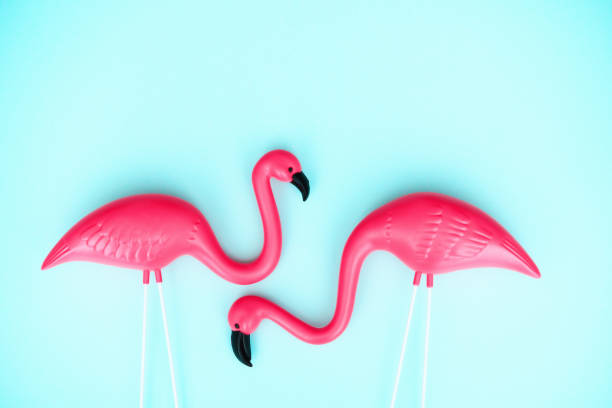 istock Summer background with a flamingo couple on a bright blue background 1386790584