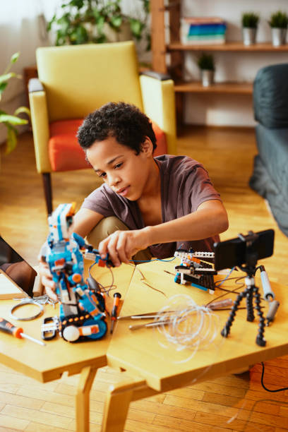 istock A little engineer building a robot at home. 1386792016