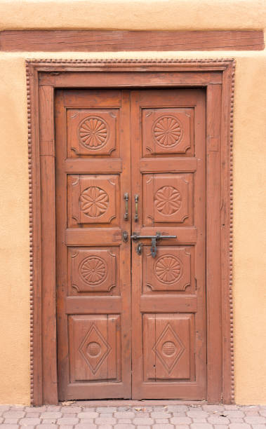 istock Santa Fe Style: Antique Wood Door in Adobe Wall 1386794021