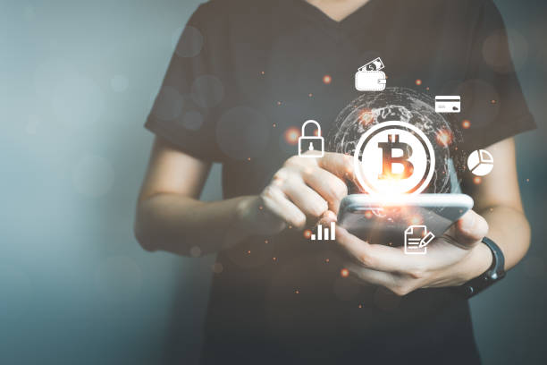 istock Businessman using smart phone to do online transactions with blockchain technology, cryptocurrencies, bitcoin, global data connection concept, big data security and a cashless society. 1386795016