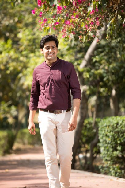 istock Happy man walking at park 1386802326