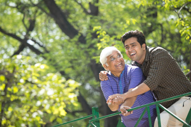 веселый старик с сыном веселится в парке - father indian ethnicity india love стоковые фото и изображения