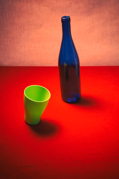 Still life with a green glass and a blue bottle