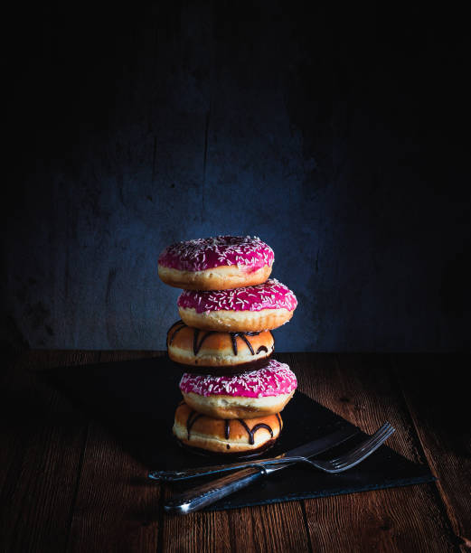 Still life of doughnuts and cookies on a wooden table