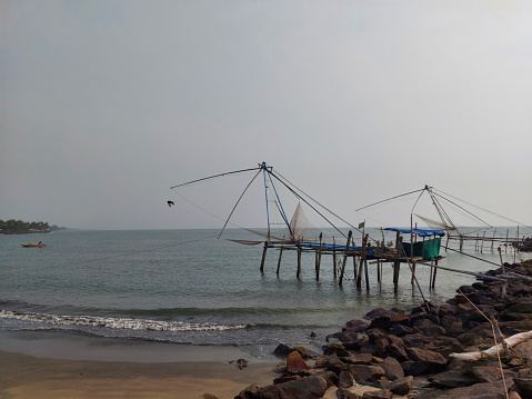 Chinese fishing net in munambam beach Kerala india and moody sky