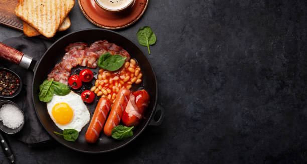 istock English breakfast with fried eggs, beans, bacon and sausages 1386813650
