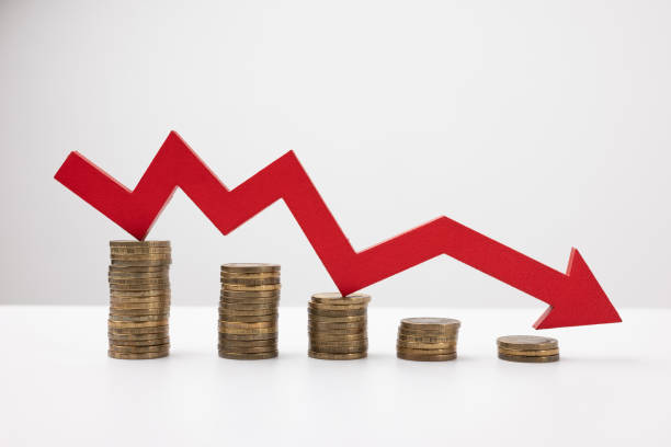 istock Red down arrow. Stack of gold coins, steps down. Money loss concept. 1386815378