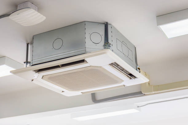 istock Modern ceiling mounted cassette type air conditioning system in the room 1386816384