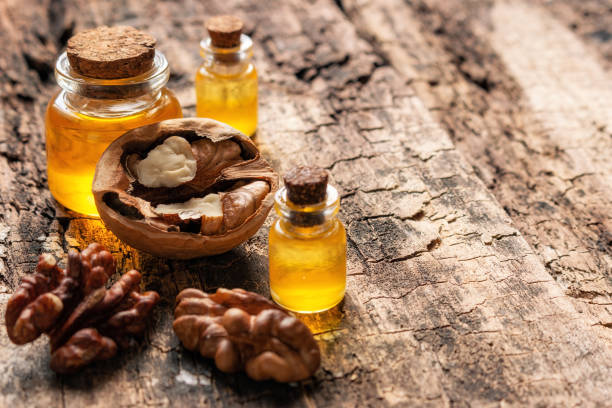 istock walnut oil on wooden background with space for text closeup 1386818807