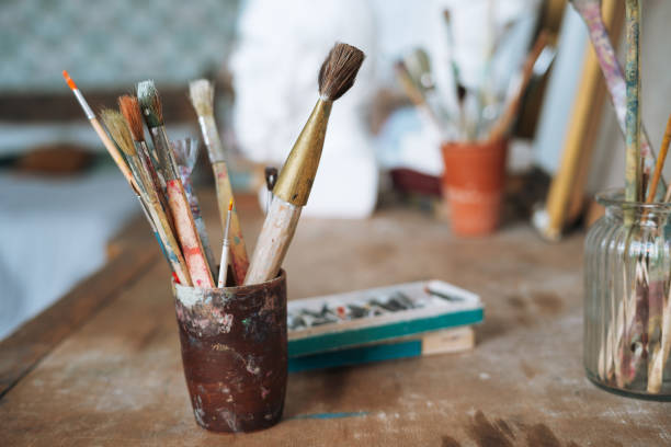 istock The brushes and paints on table in art studio 1386819095