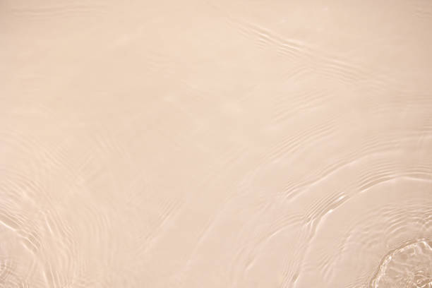 istock transparent beige colored clear calm water surface texture 1386820628