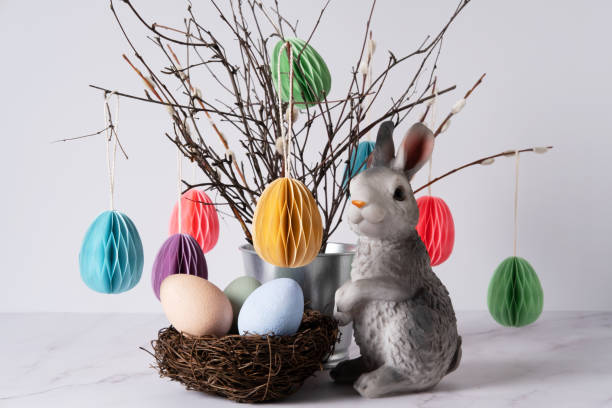 istock Easter arrangement with tree branches, paper eggs, a nest and an Easter bunny. 1386822322