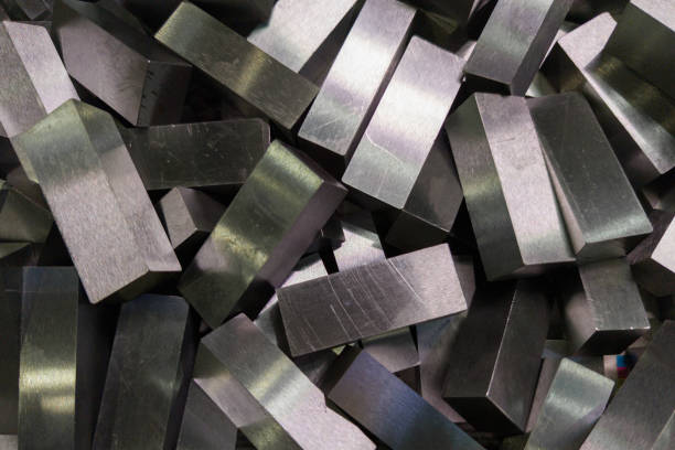a pile of shiny faceted steel blocks - full frame close-up with selective focus a pile of shiny faceted steel blocks - full frame close-up with selective focus, view directly from above alloy stock pictures, royalty-free photos & images