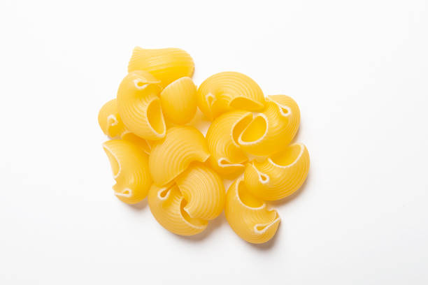 istock Tasty uncooked pasta on white background. 1386823762