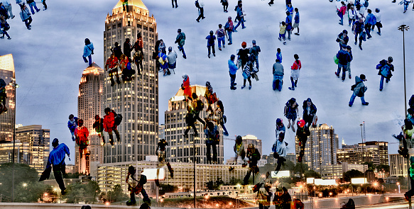 Shot of unrecognizable people climbing on skyscrapers and to the sky superimposed over an illuminated cityscape. The city is Atlanta - Georgia, USA.