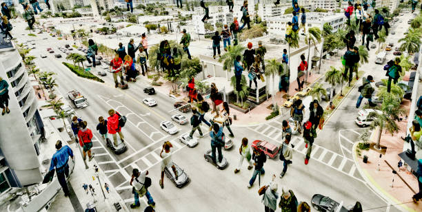 Shot of unrecognizable people walking on streets. The city is Miami, Florida, USA.