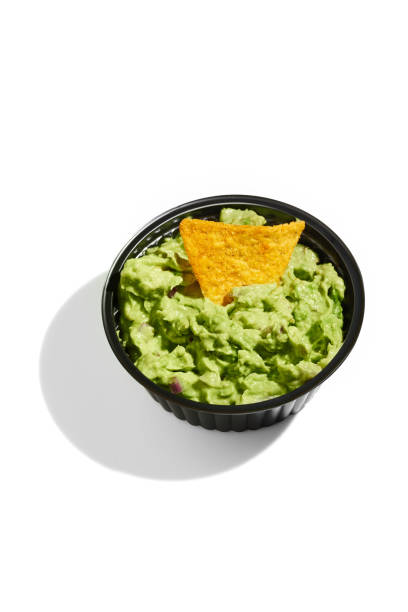 istock Mexican nachos with avocado guacamole on a white background. Hard Light 1386827100