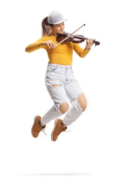 istock Modern female violinist playing a violin and jumping 1386827547