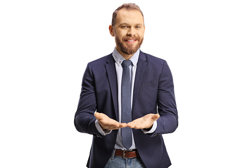 Young professional man holding something imaginary in his hands and smiling isolated on white background