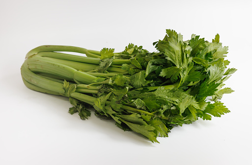 Celery sticks with leaves on white background, organic food, studio shot