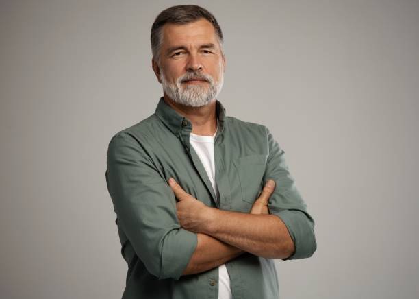 portrait of smiling mature man standing on white background - beautiful looking caucasian one person imagens e fotografias de stock