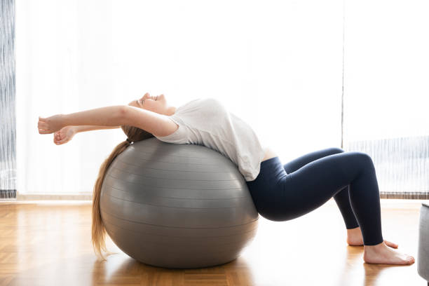 istock Woman practicing balance on gymnastic ball 1386836666