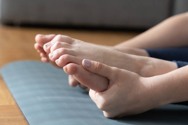 istock Closeup view of hands holding feet 1386836709