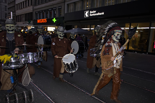 BASEL, SWITZERLAND - March 9, 2022: Fasnacht festival in the year 2022. It is a famous Carnival of Switzerland Walking down the street wearing traditional masks.