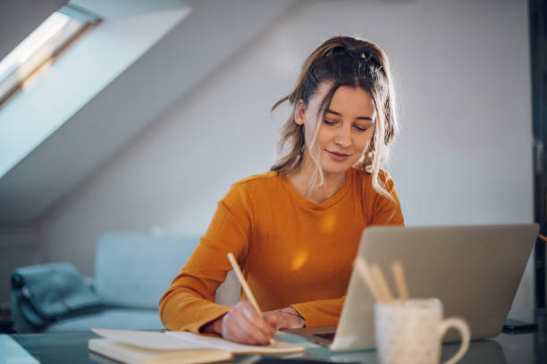 istock Woman working from a home on her a laptop 1386837845