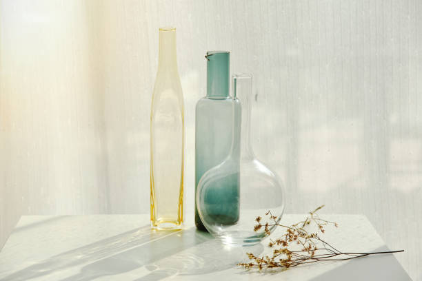 istock Glassware reflect sunlight shadow effect, Summer still life scene, Transparent glittering glasses of water, Warm light vibe in sunny day. 1386840582