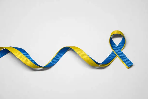 Photo of Blue and yellow ribbon for Ukraine on white background with clipping path