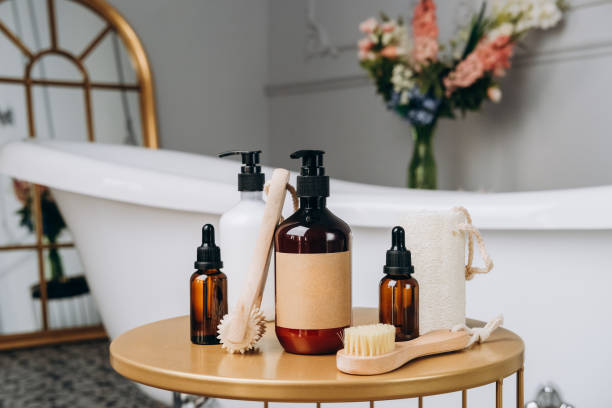 shampoo shower gel  Lotion, cream, massage brushes and anti-cellulite in a basket on the table near the bathtub in the bathroom . Body and face care beauty bath set. body care and face care body care shower stock pictures, royalty-free photos & images