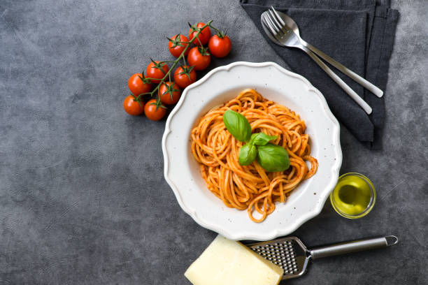 istock Plate of spaghetti with tomato sauce and basil and cheese top view 1386840707