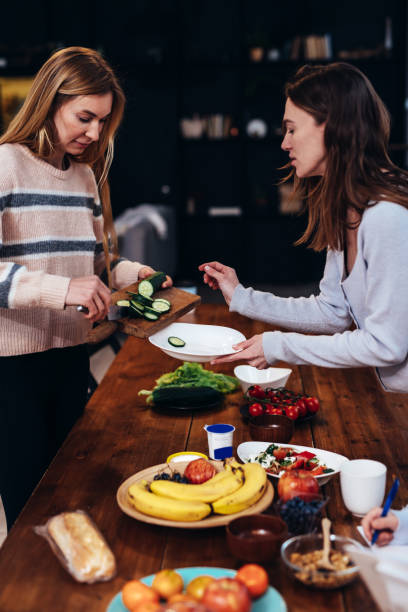 istock Two young women are cooking a meal 1386842015