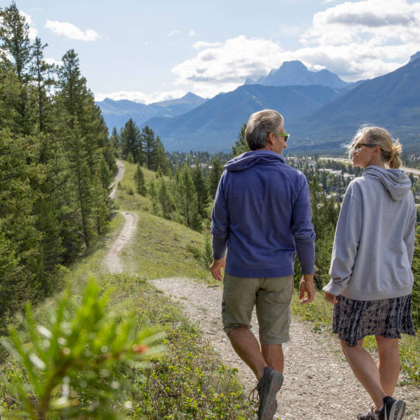istock Mature couple hike above valley and forest, mountains 1386842404