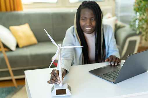 Portrait of a young student working on a windmill project for renewable energy