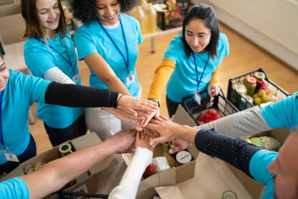 istock Arms outstretched with hands stacked 1386842648