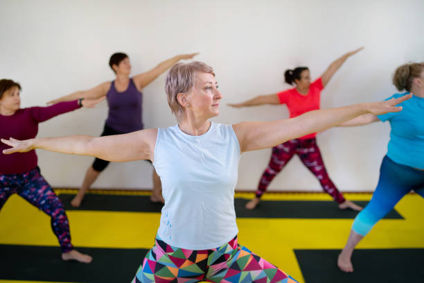 istock Women standing with arms outstretched during exercise class 1386842768