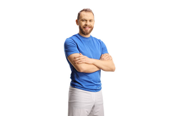 istock Athlete in a blue jersey and white shorts posing and smiling 1386843017