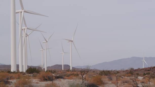istock Windmills on wind farm, wind mill energy generators. Desert windfarm, USA. 1386843540