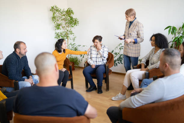 istock A woman standing in a therapy group 1386844090