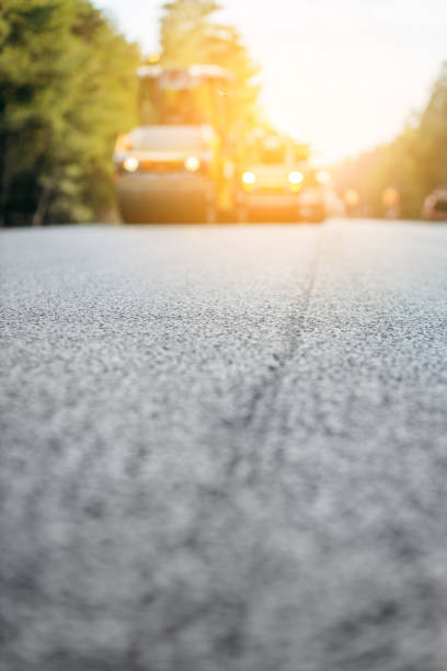 istock Vibratory asphalt rollers compactor compacting new asphalt pavement. Road service repairs the highway 1386844445