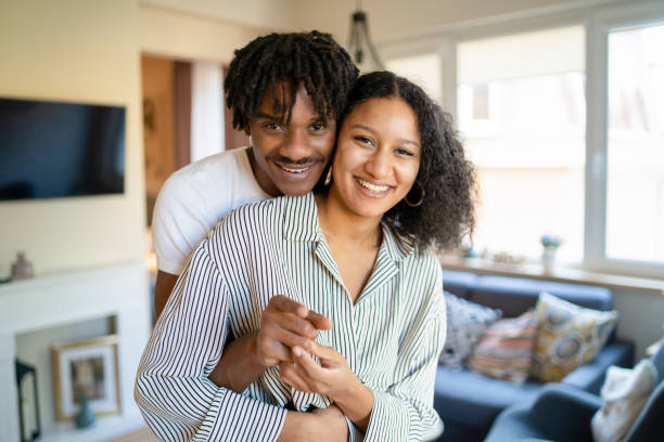 istock A husband and wife smiling as they cuddle playfully 1386844502