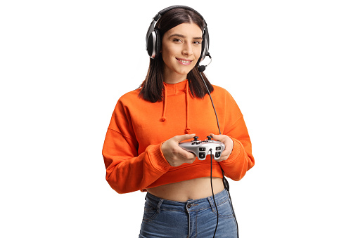 Cheerful young female with headphones and joystick isolated on white background