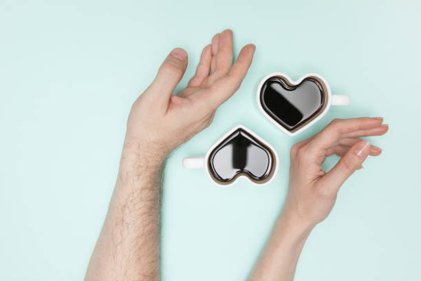 istock Woman's hands and heart shaped cup of coffee. 1386844702