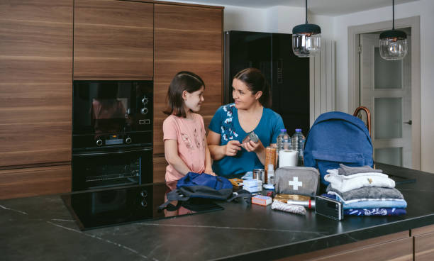 istock Mother explaining to her daughter how to prepare emergency backpack 1386845797