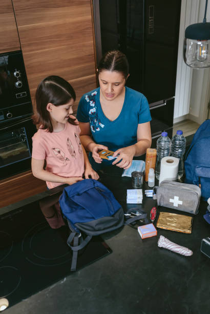 istock Mother preparing emergency backpack with her daughter 1386845805