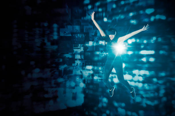 Happy young woman wearing VR goggles while jumping in the cyberspace with virtual screen background