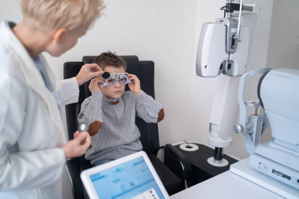 istock Female ophthalmologist examing a young boy during an eye tests 1386850255